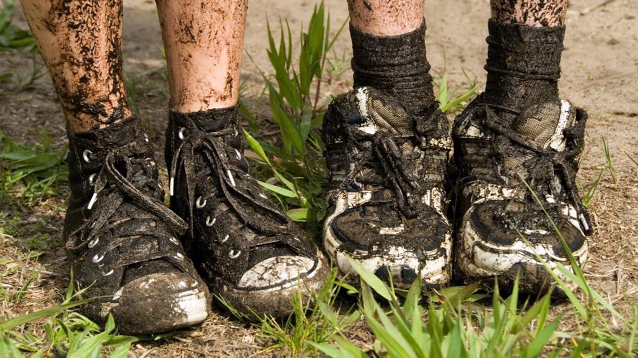 Dirty muddy hiking shoes.
