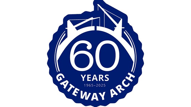 A blue and white logo. The text inside says "60 years of the Gateway Arch"