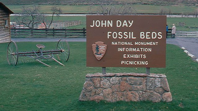 Sign says John Day Fossil Beds National Monument Information Exhibit Picnicking with NPS arrowhead