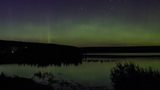 The Northern Lights above a lake.