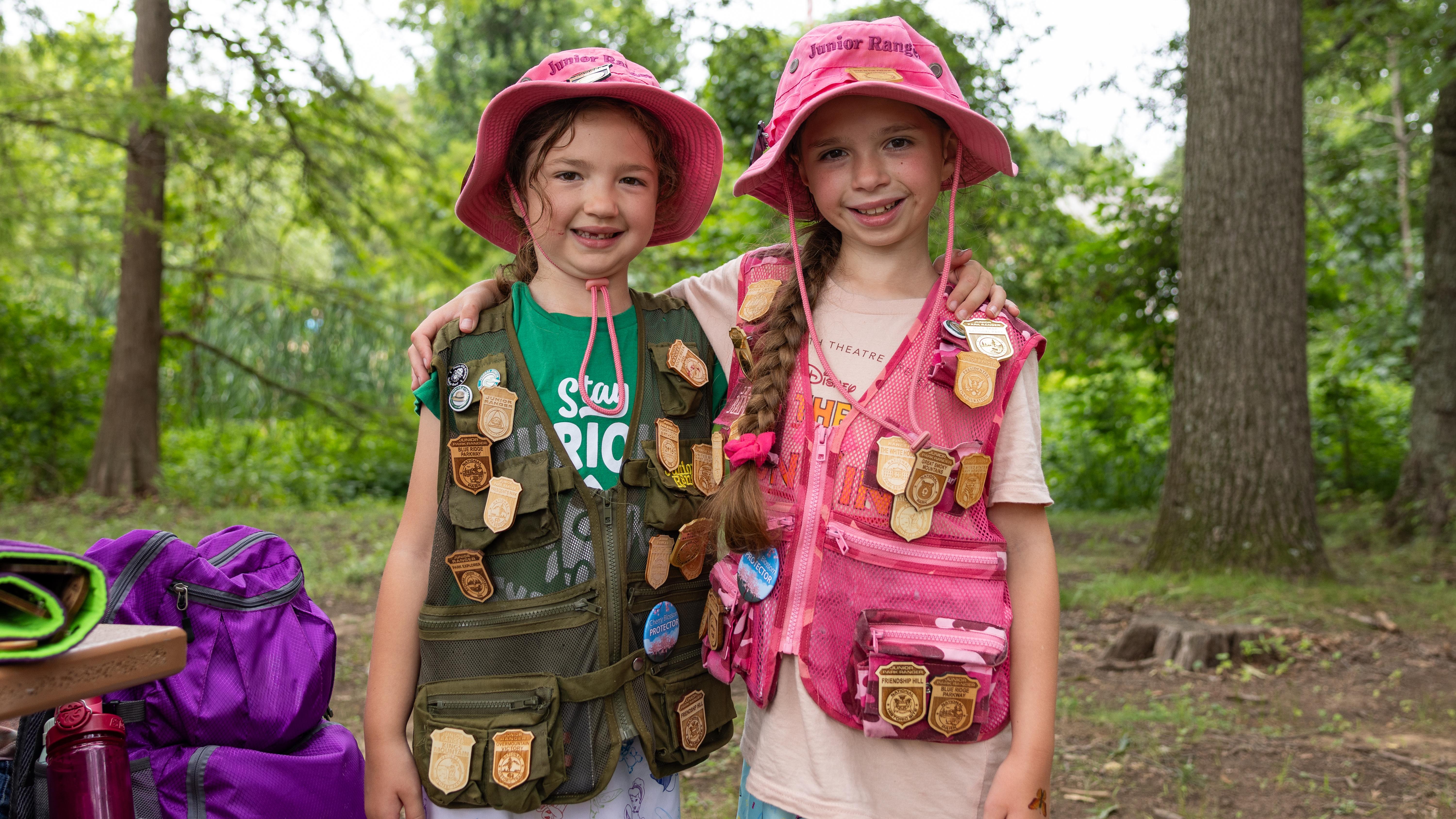 Two Junior Rangers display their Junior Ranger badge collections at Kenilworth Aquatic Gardens