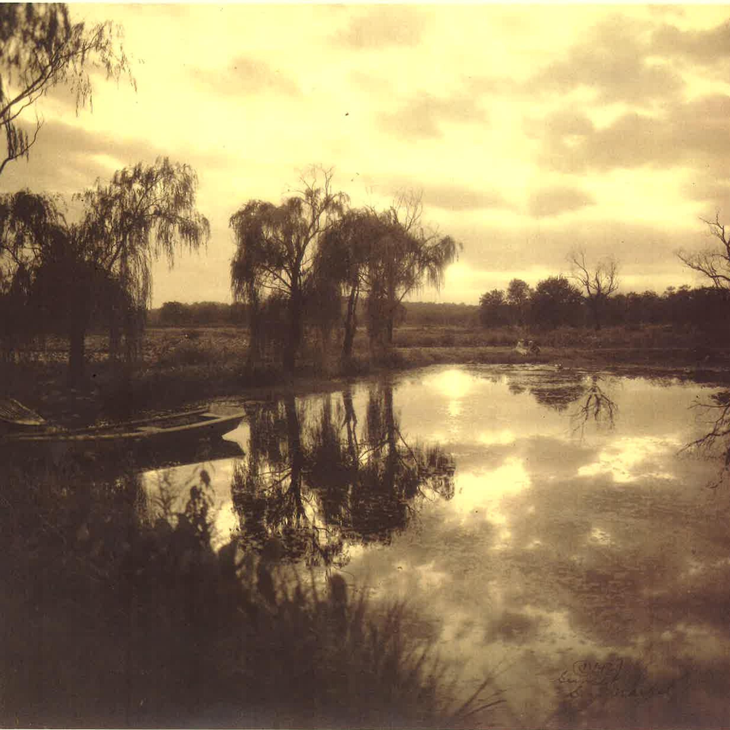 An old brown sepia photo of lakes and trees.