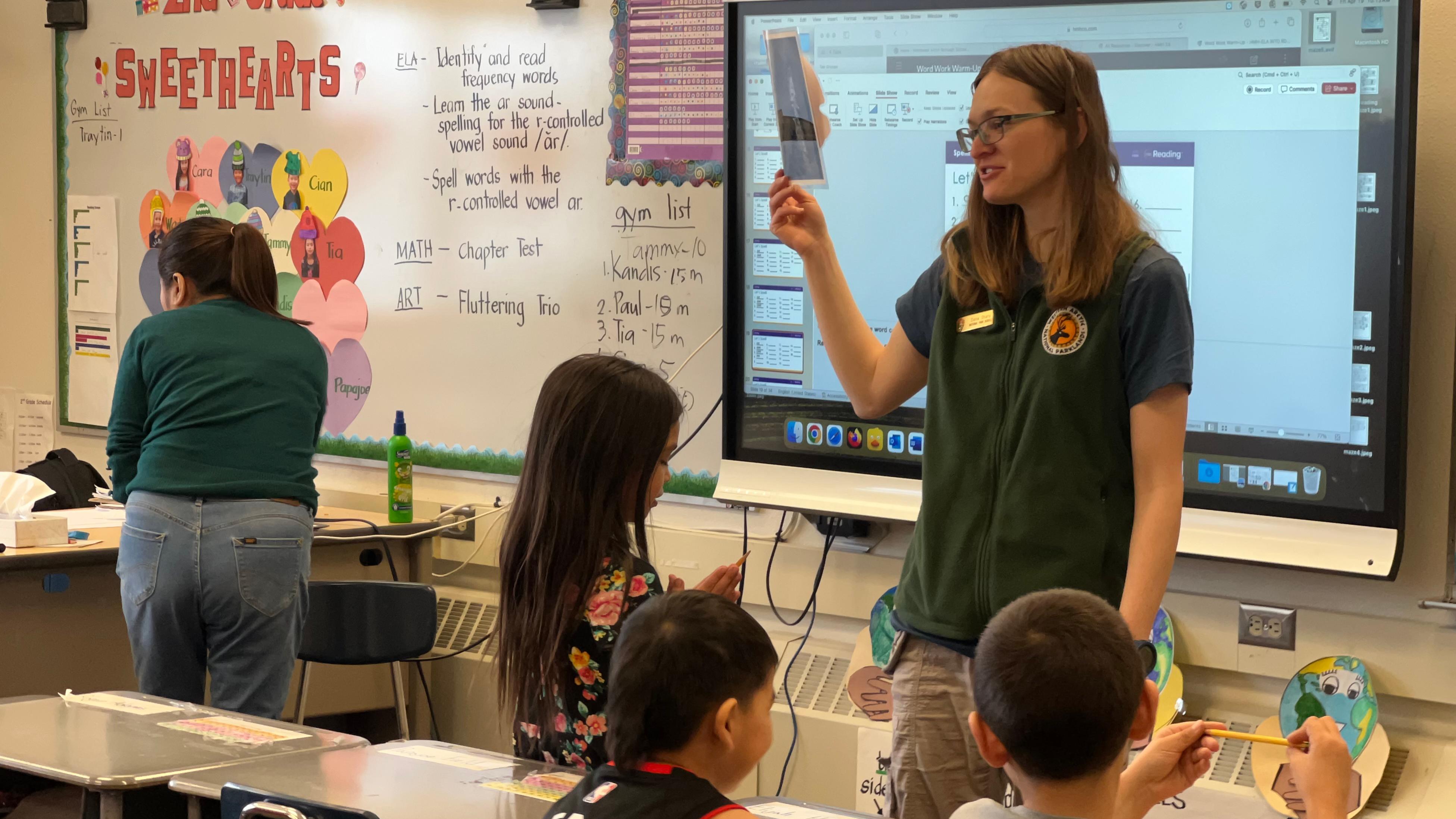 Ranger speaks with 2nd graders in a classroom setting.