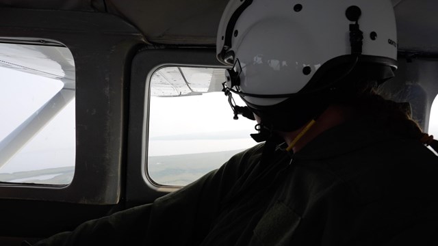 Women in bush plane looking out window