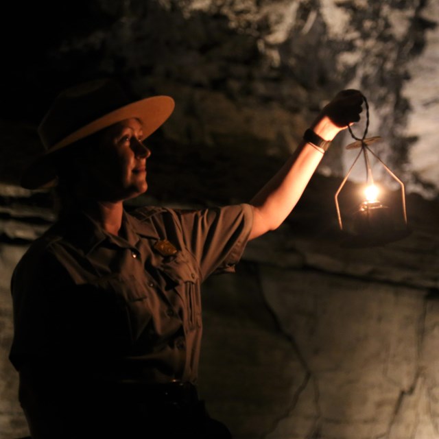 Two park visitors waling along a trail in the cave