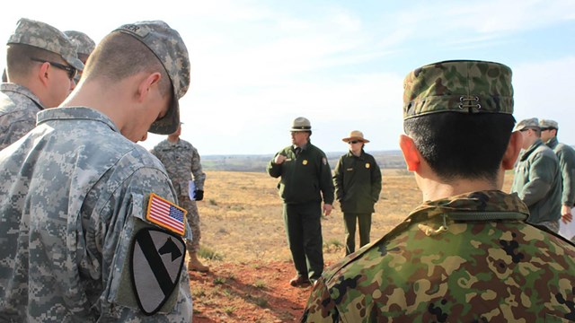 Soldiers and park rangers on the battlefield.