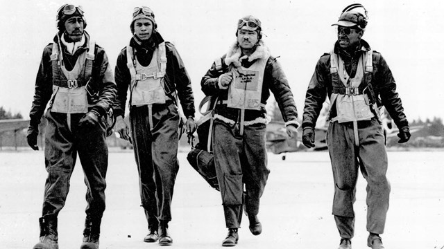 WWII African American airmen walking down a runway