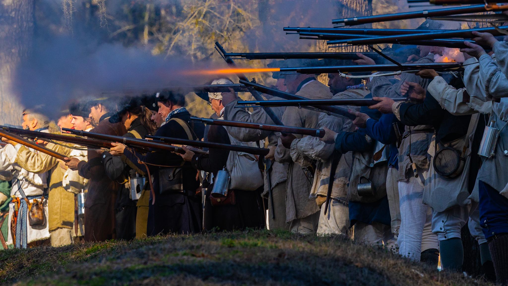 Row of Reenactors firing muskets