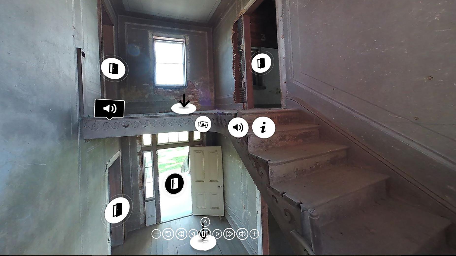 A staircase wraps upward to the second floor of the house