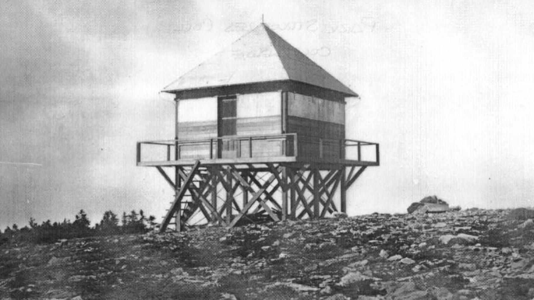 A black and white photo of a former fire lookout.