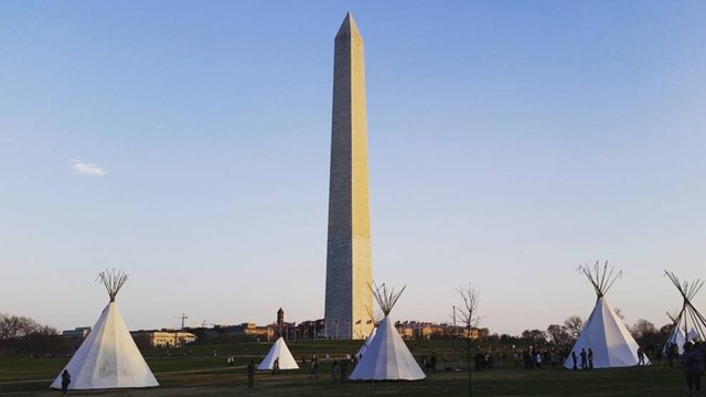 Tipis with the Washington Monument in the background