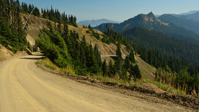 A dirt road along a mountainside.