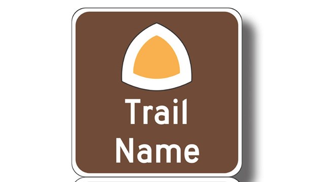 A brown rectangle sign, "Trail Name, National Historic Trail," with a yellow triangle.