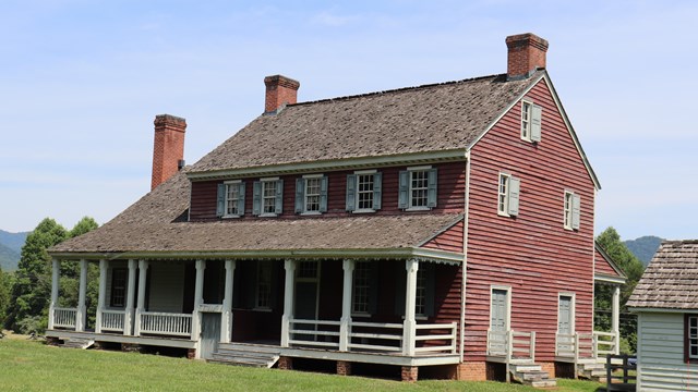 A red clapboard house with white porch