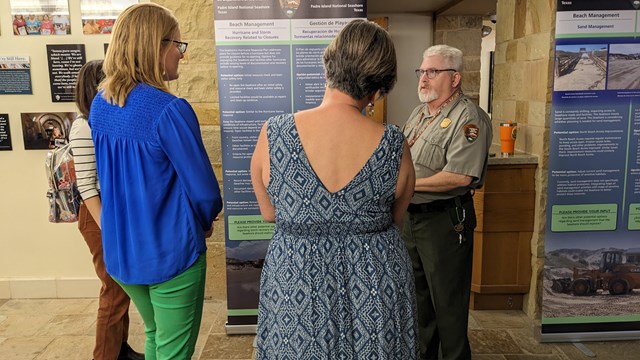 Community members talk with a park employee during a park planning event. 