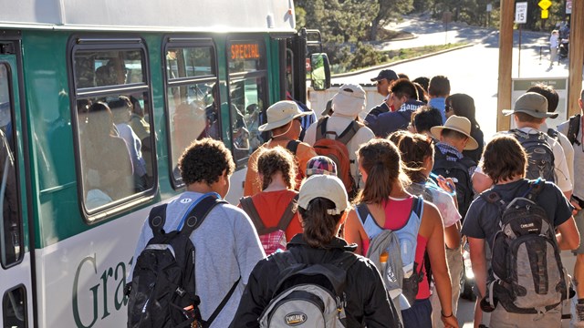 Large group of park visitors about to board a park shuttle bus