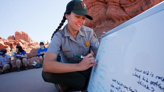 Park Ranger writing on a white board