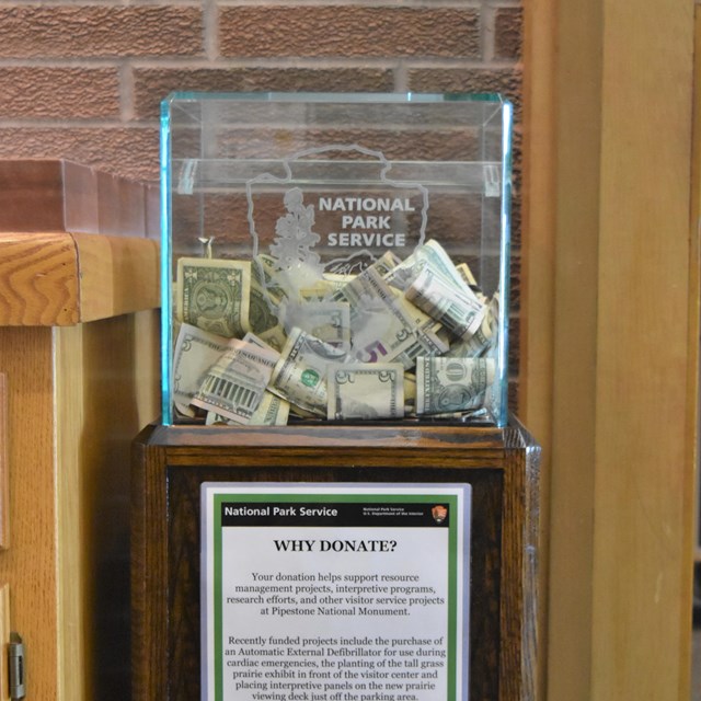 A photo of a glass donation box