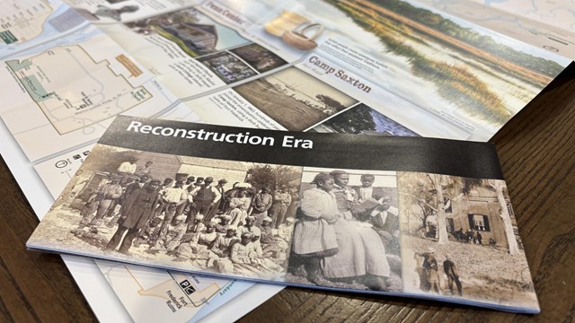 A brochure for Reconstruction Era National Historical Park sits on an open version of the brochure.