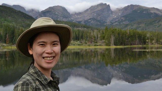 Dr. Lei-Wei Hung is standing in front of an alpine lake