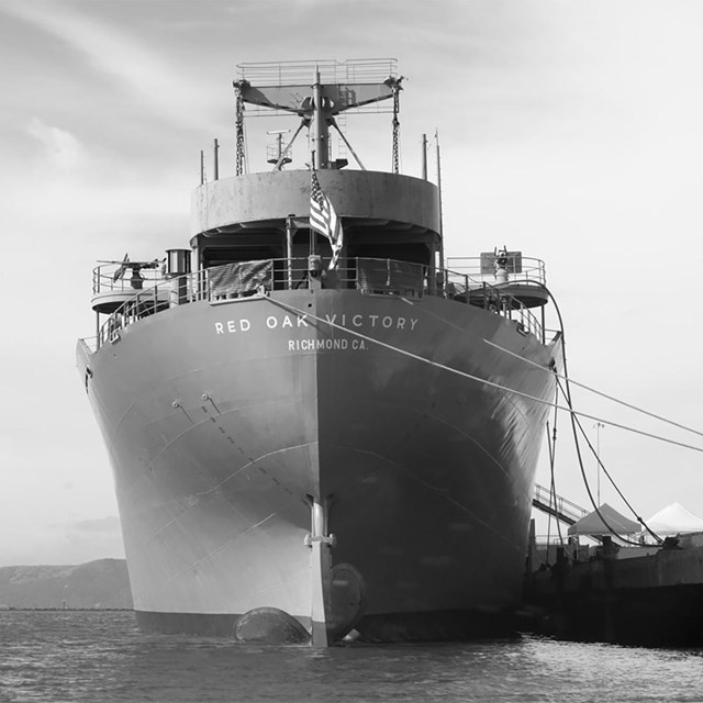 A modern photo of the SS Red Oak Victory ship, taken from the front view. 