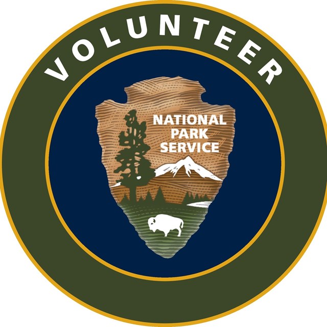 Official Volunteer logo showing an NPS shield graphic in a circle with the word 