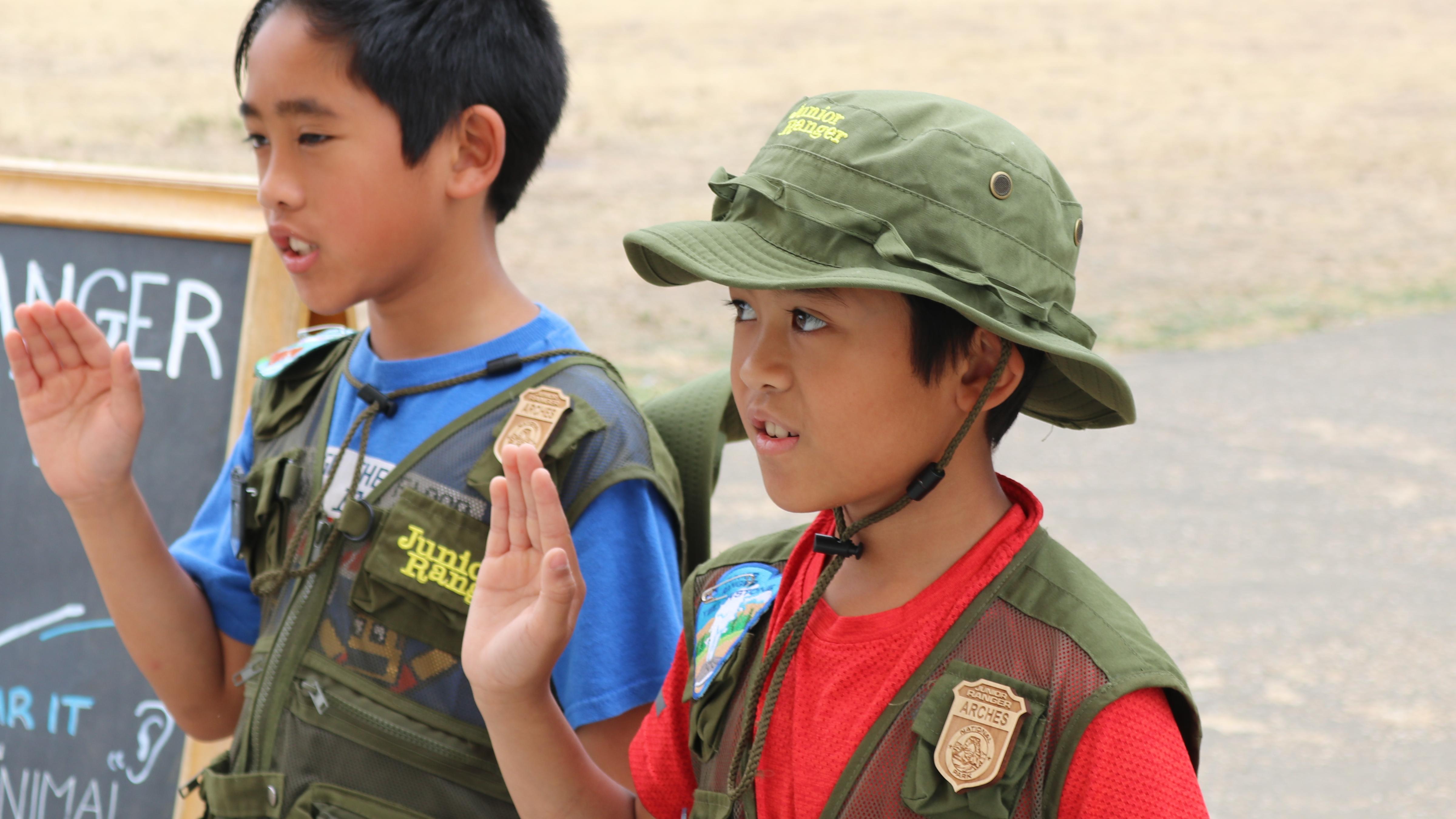 Two boy saying a pledge.