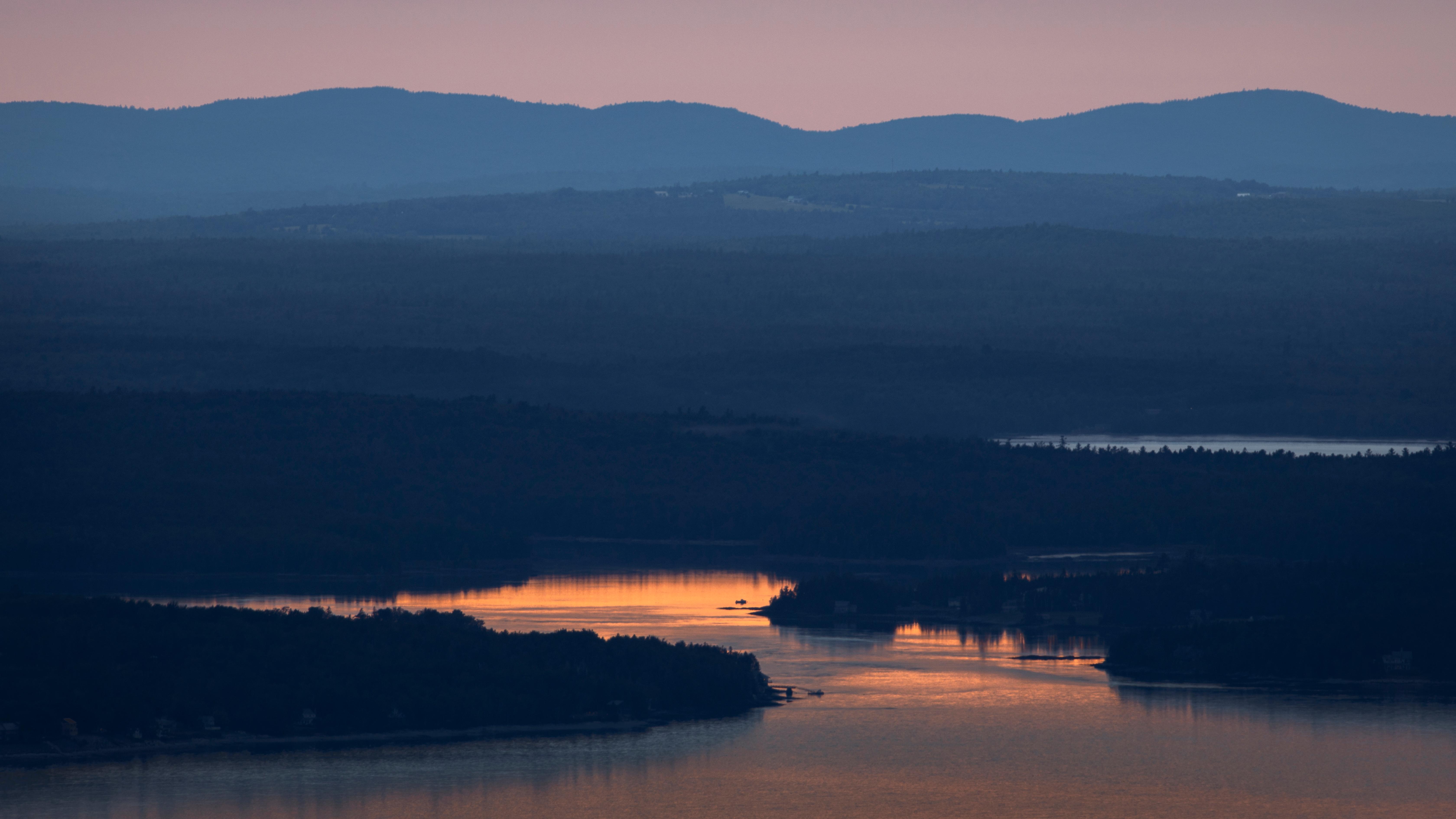 The setting sun over Downeast Maine National Heritage Area from a distance.