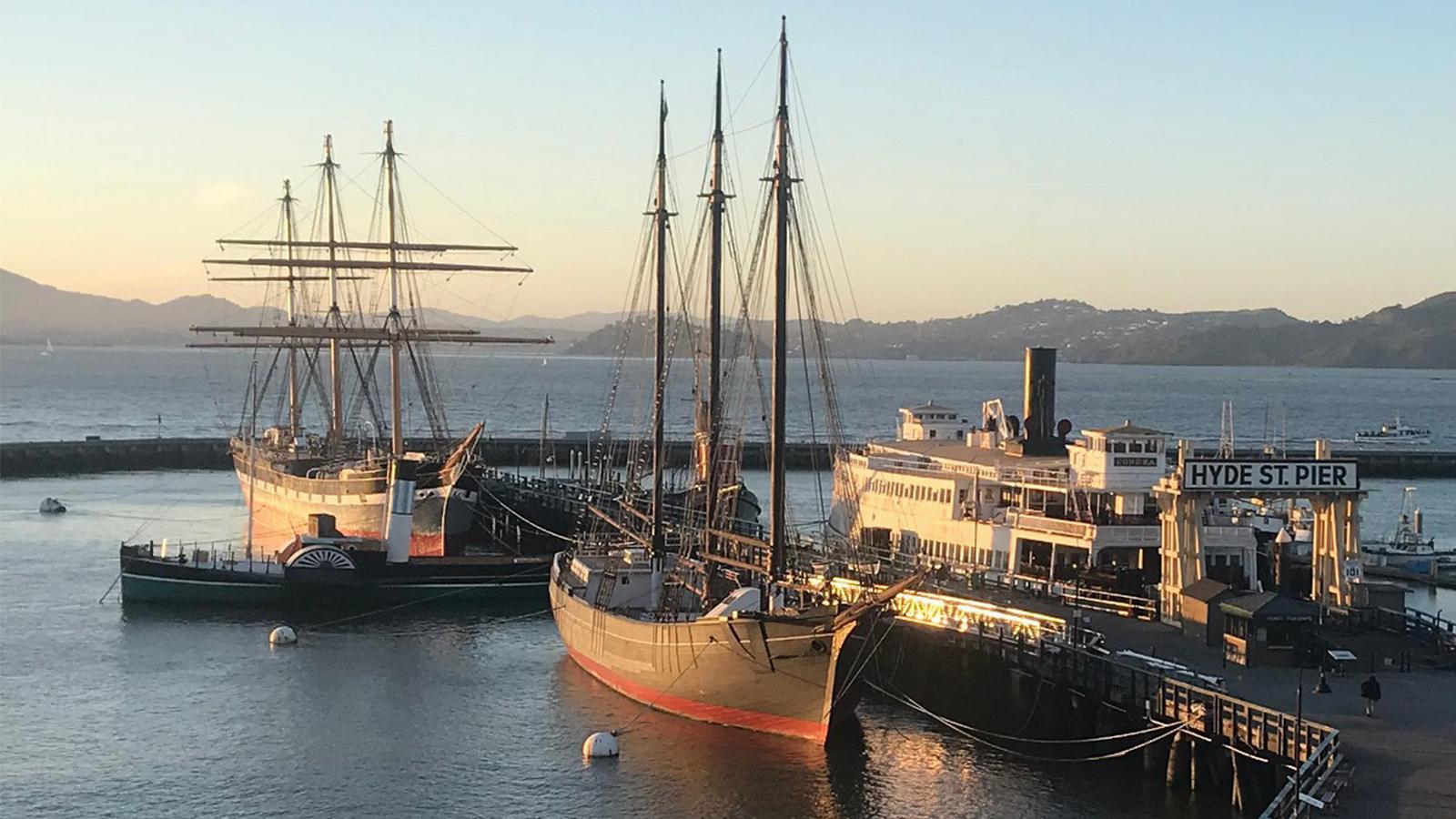 View of Hyde Street Pier and ships in the sunset