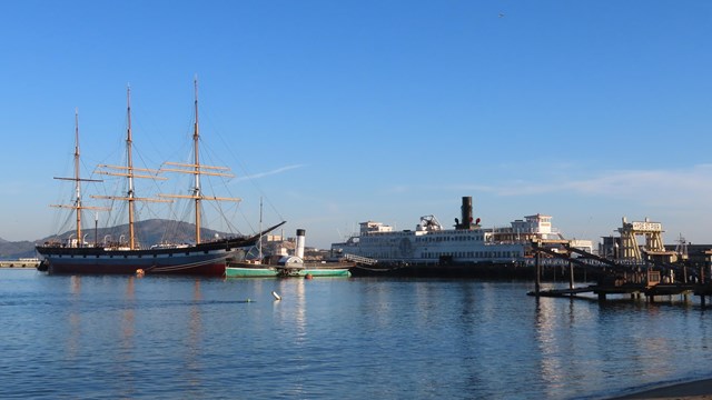 the historical ships Balclutha, Eureka, and Eppleton Hall are docked to Hyde Street Pier.