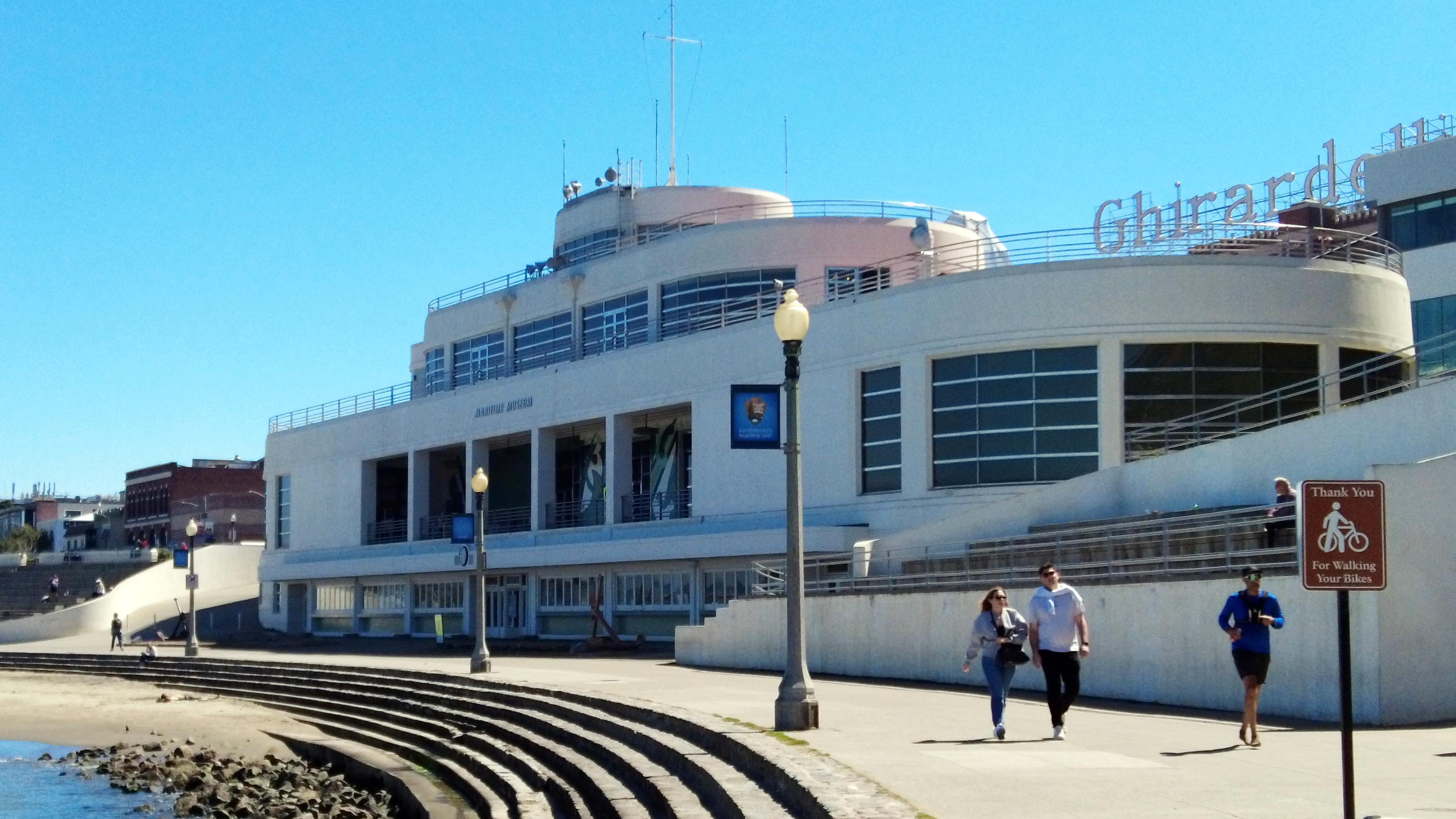 a white building designed to look like an ocean liner ship near a rocky shoreline