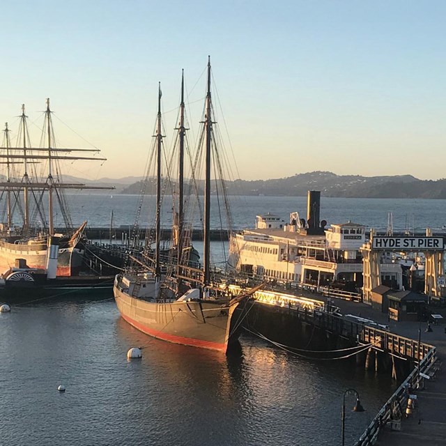 View of Hyde Street Pier and ships in the sunset