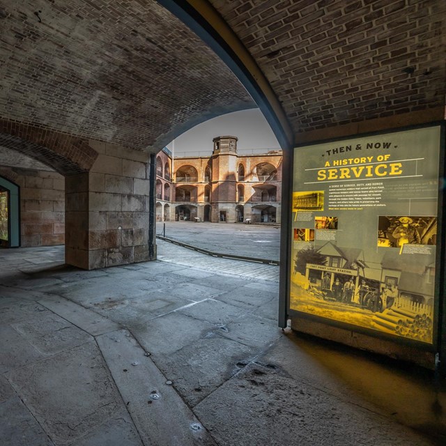 The brick interior of a room in Fort Point is lit with dramatic gray lighting