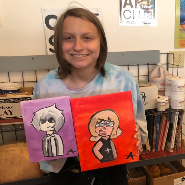 A young artist displays their work