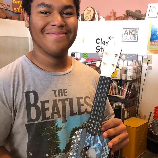 A young artist displays their work