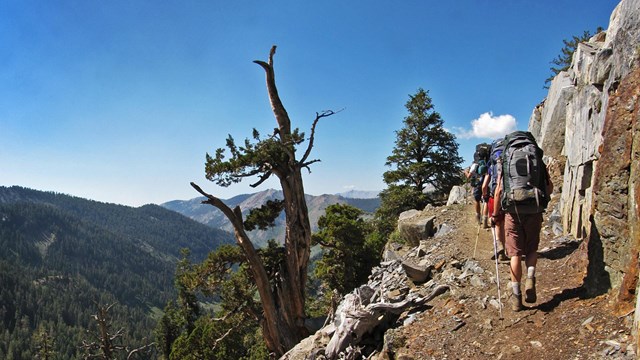Hikers climb an alpine trail toward Franklin Lakes