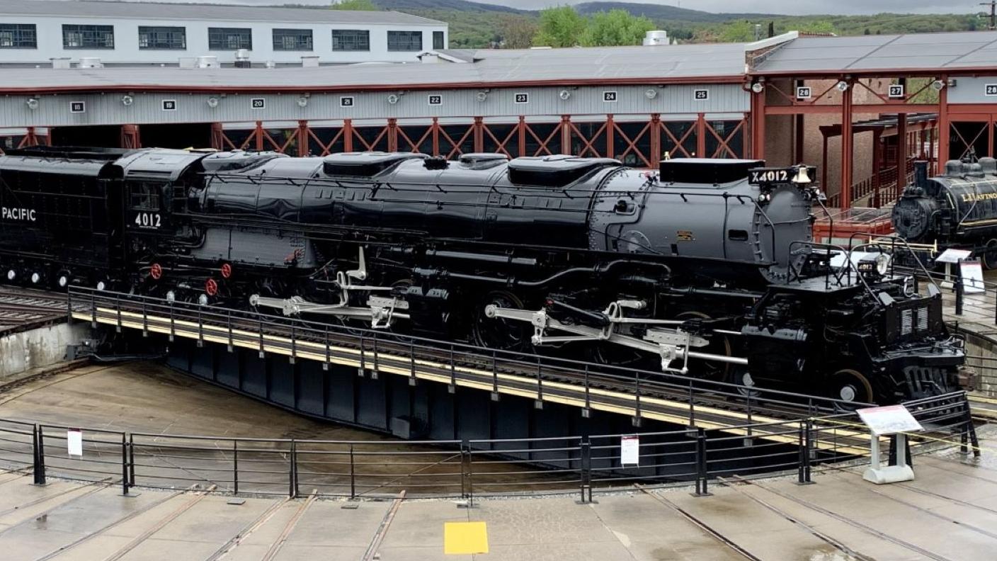 Steam locomotive with a light dusting of snow amid snow flurries
