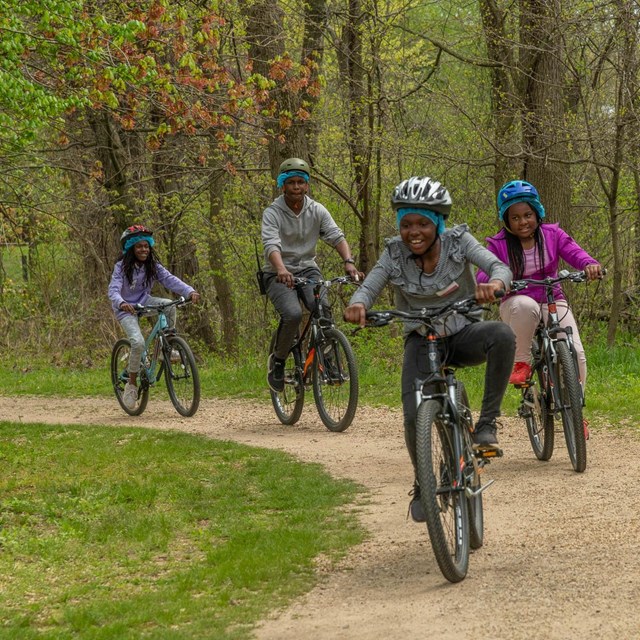 A family riding bikes on a trail.