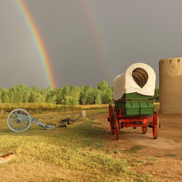 Double rainbow over covered wagon Bent's Old Fort along the Santa Fe Trail 