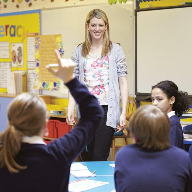 Teacher in front of students. Public domain.