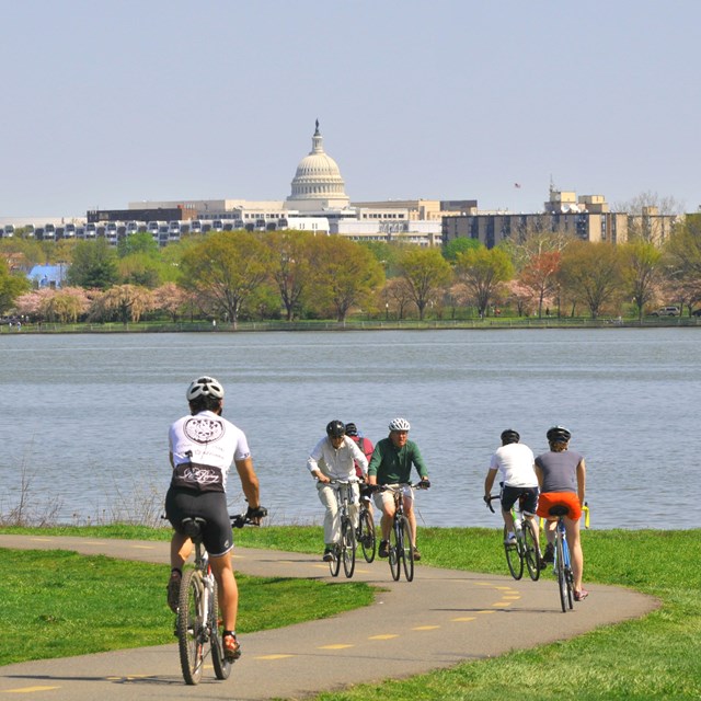 Cyclists on the Mount Vernon Trail across from Capital Hill.