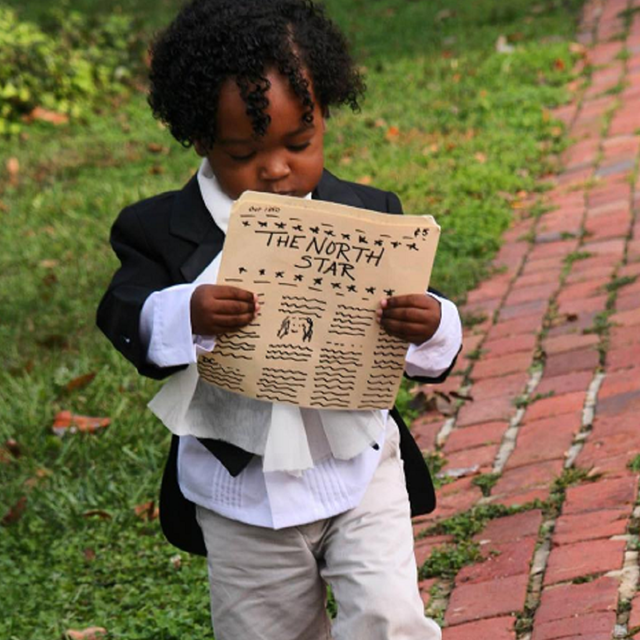 A young visitor dressed up as Frederick Douglass