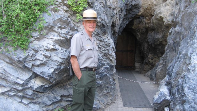 Ranger standing by the entrance to Hansen Cave