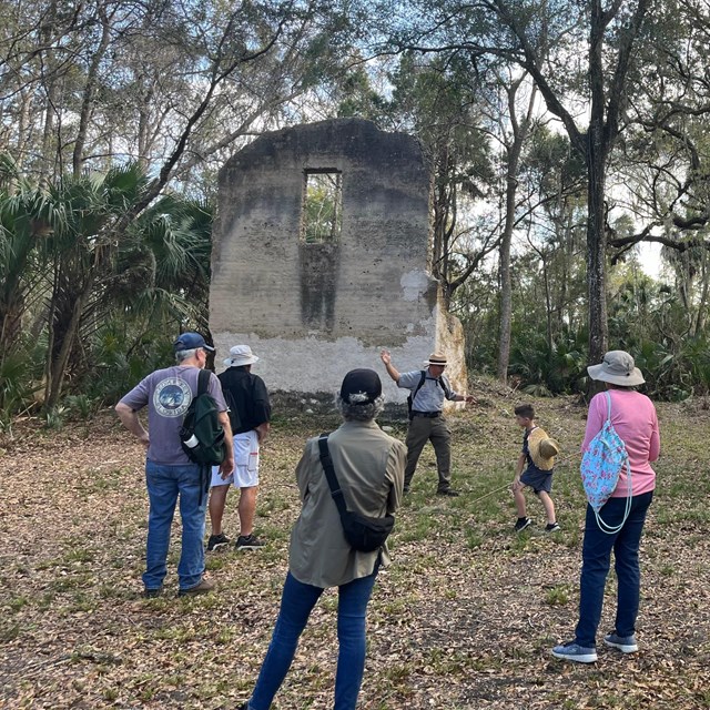 ranger giving tour at two story tabby palnattion ruins in the woods 