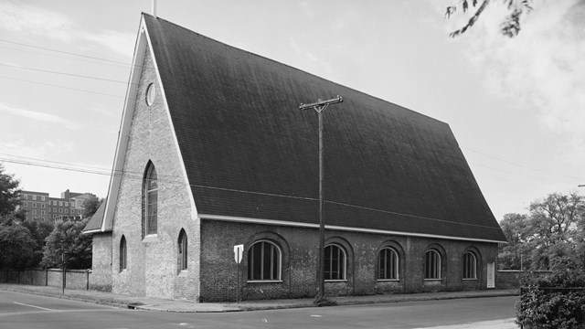 Black and white photo of artillery shed turned church. 