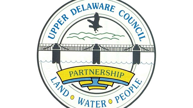Circular logo with text "Upper Delaware Council Partnership. Land, Water, People" and bridge & eagle