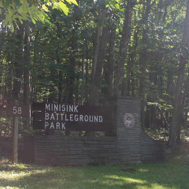 Stone and wood sign reading 