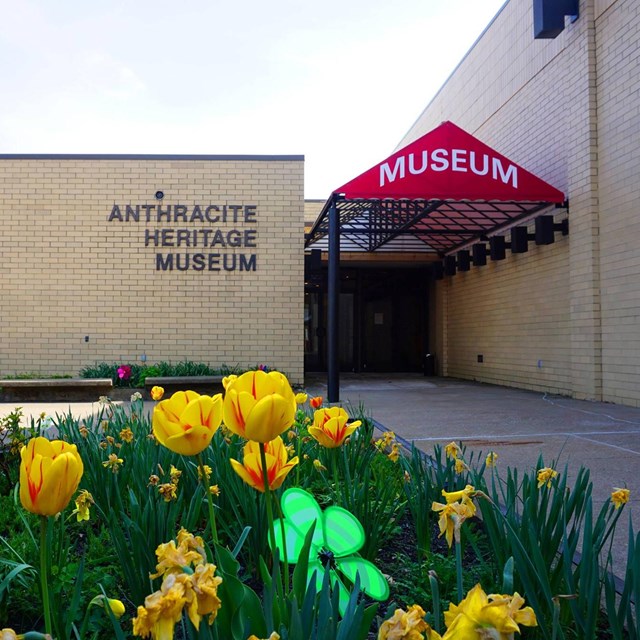 Brick building with flowers and sign