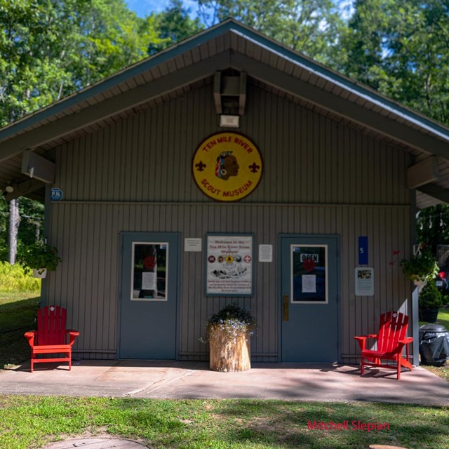 Simple wooden plank building with Scouting USA Insignia