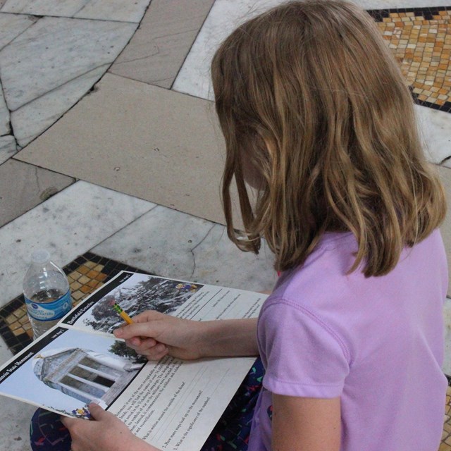A young girl completes an activity about Vicksburg National Military Park